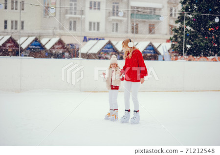 Cute and beautiful family in a winter city Cute and beautiful family in a winter city 71212548