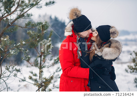 Loving couple walking in a winter park Loving couple walking in a winter park 71216424
