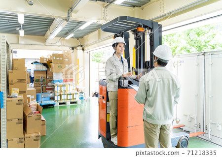 Female worker driving a forklift Female worker driving a forklift 71218335