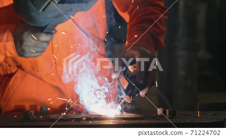 Metal welder working with arc welding machine Metal welder working with arc welding machine 71224702