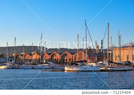 Sunrise in Old Venetian port, Chania, Crete, Greece. Sailing boats, yachts, pier, Old Venetian shipyard. Bell tower of Greek church, Cretan mountains Sunrise in Old Venetian port, Chania, Crete, Greece. Sailing boats, yachts, pier, Old Venetian shipyard. Bell tower of Greek church, Cretan mountains 71225404