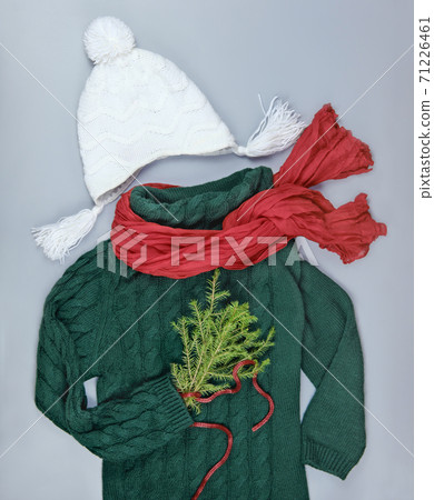 dark green pullover with red scarf and white hat 71226461