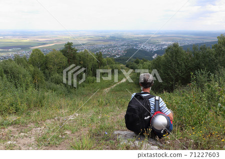 Man sitting by the trail on Mount Tserkovka Man sitting by the trail on Mount Tserkovka 71227603