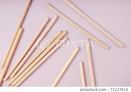 Bamboo straws straws on pink background. 71227618