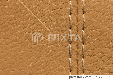 Artificial leather car upholstery, color beige, close-up stitching in macro mode Artificial leather car upholstery, color beige, close-up stitching in macro mode 71228092