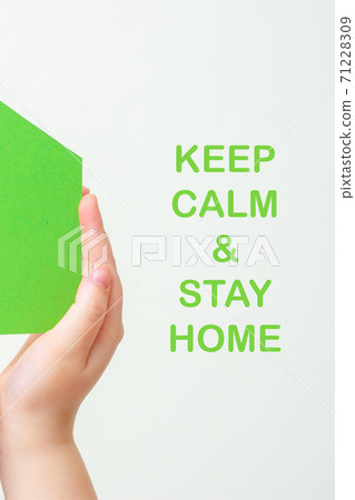 Hands holds green paper house. Hands holds green paper house. 71228309