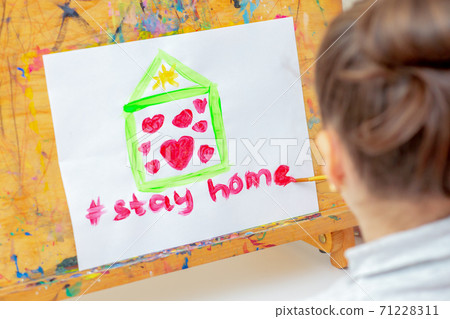 Child is drawing house with hearts. Child is drawing house with hearts. 71228311