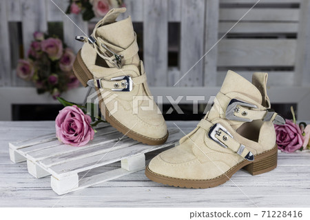 Female leather shoes on rustic wooden surface 71228416