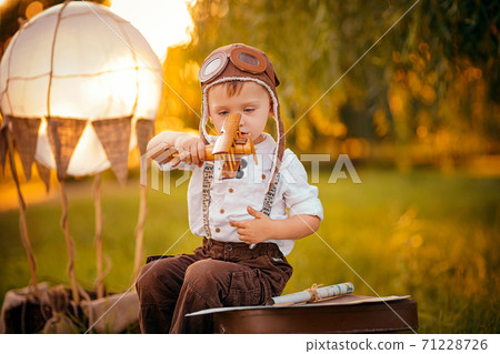 A little boy dreams of becoming a pilot. Vintage aviation hat 71228726