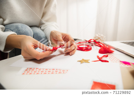 Woman making greeting card for New Year and Christmas 2021 for friends or family, scrap booking, DIY Woman making greeting card for New Year and Christmas 2021 for friends or family, scrap booking, DIY 71229892