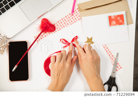 Woman making greeting card for New Year and Christmas 2021 for friends or family, scrap booking, DIY Woman making greeting card for New Year and Christmas 2021 for friends or family, scrap booking, DIY 71229894