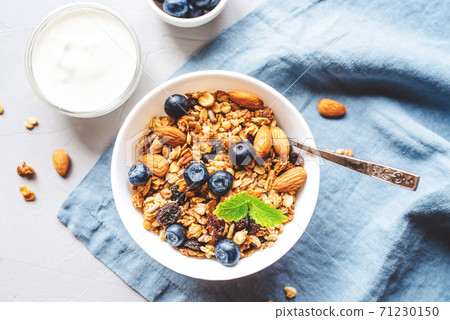 Baked granola with yogurt and blueberries. Baked granola with yogurt and blueberries. 71230150