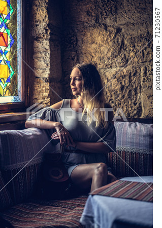 Portrait of young beautiful woman in asian restaurant sitting on the sofa Portrait of young beautiful woman in asian restaurant sitting on the sofa 71230567