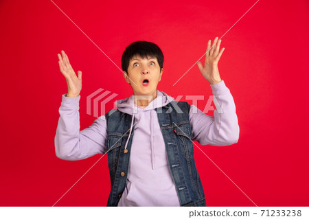 Senior woman isolated on red background. Tech and joyful elderly lifestyle concept Senior woman isolated on red background. Tech and joyful elderly lifestyle concept 71233238