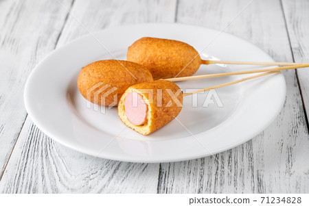Corn dogs on white serving plate Corn dogs on white serving plate 71234828