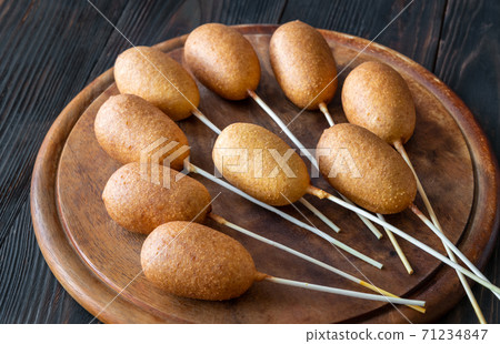 Corn dogs on wooden board 71234847