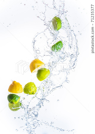 Fresh limes and lemons with water splash in midair, isolated on white background 71235377