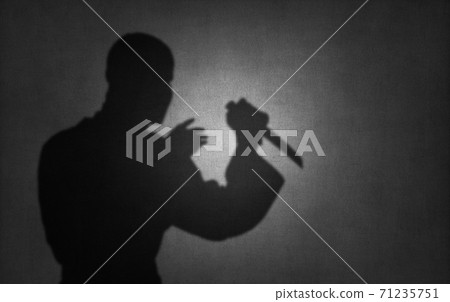 killer or terrorist with knife, shadow on wall killer or terrorist with knife, shadow on wall 71235751
