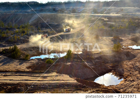 Mining dump truck transports sand and other minerals in the quarry. 71235971