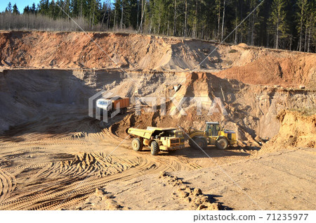 The work of heavy machinery and mining trucks in the open pit mine 71235977