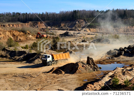 Mining dump truck transports sand and other minerals in the quarry. Mining dump truck transports sand and other minerals in the quarry. 71236571
