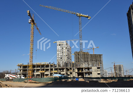Heavy mixer concrete truck waiting for to be loaded concrete at a construction site. Heavy mixer concrete truck waiting for to be loaded concrete at a construction site. 71236613