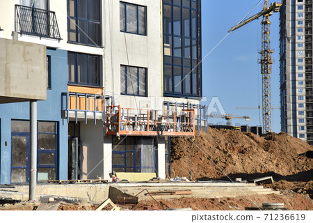 Suspended construction cradle on the background facade of the building.  71236619