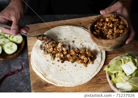 man preparing a durum or a burrito man preparing a durum or a burrito 71237026
