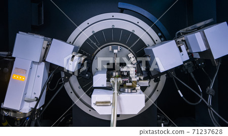 The magnification hand controls a high magnification camera like a machine with a monitor in a lab. The magnification hand controls a high magnification camera like a machine with a monitor in a lab. 71237628