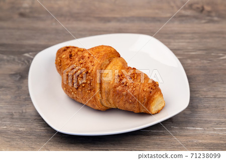 A delicious croissant on a plate 71238099