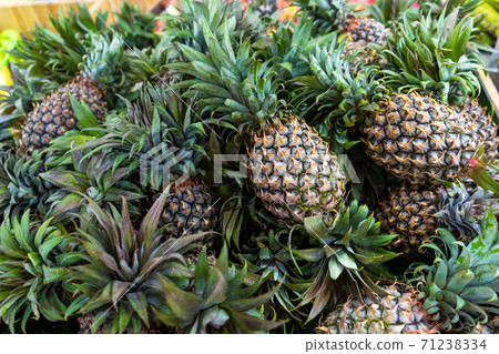 Freshly cut pineapples on the counter of a street food market 71238334