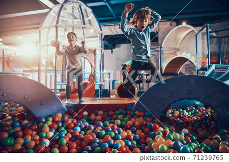 Two children are happy while jumping into pool. Two children are happy while jumping into pool. 71239765