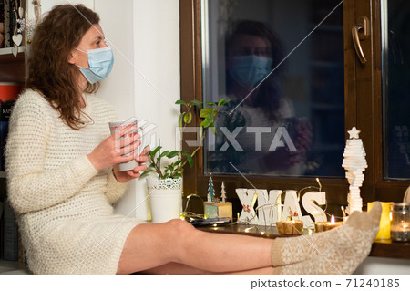 woman in quaratine at home during Christmas 71240185