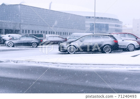 Cars on parking during snowfall in winter. Cars on parking during snowfall in winter. 71240493