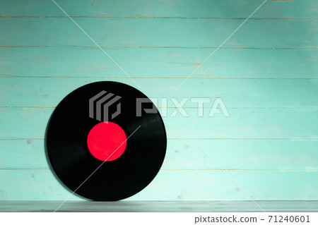 Vinyl record on green wooden background 71240601
