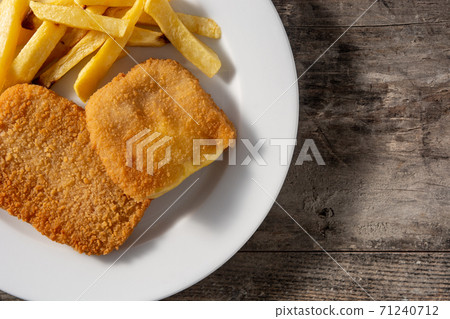 San Jacobo steak filled with cheese and ham on wooden table 71240712