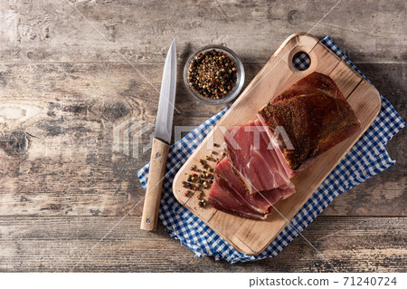 Dried and smoked meat on wooden table Dried and smoked meat on wooden table 71240724