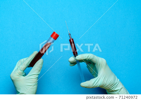 lab technician assistant or doctor holding a blood sample in test tube 71240972