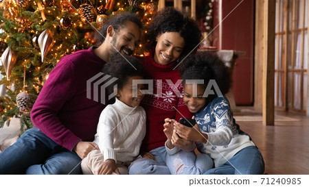 Close up happy African American family using smartphone, winter holidays 71240985