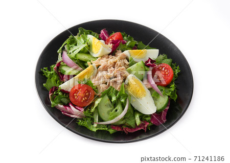 Salad with tuna, egg and vegetables on black plate isolated on white background 71241186
