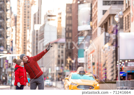 Family of father and little kid on Times Square during their vacation in New York City 71241664