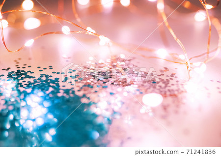 Pink and blue sparkles and lights on the pink background. 71241836