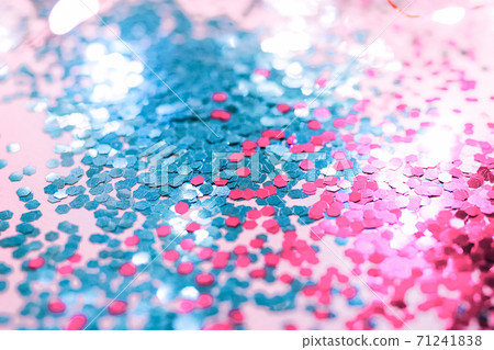 Pink and blue sparkles and lights on the pink background. 71241838