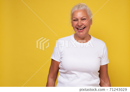 Beautiful elderly lady with a lively smile looking directly at the camera Beautiful elderly lady with a lively smile looking directly at the camera 71243029