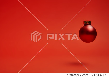 New Year's toy hovering in the air on a red background New Year's toy hovering in the air on a red background 71243714