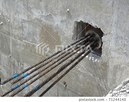 JOHOR, MALAYSIA -APRIL 14, 2017: Pre-stress cable tendons anchor end for pre-stressed concrete at the construction site. It is a technology to get better concrete slab quality with larger span. JOHOR, MALAYSIA -APRIL 14, 2017: Pre-stress cable tendons anchor end for pre-stressed concrete at the construction site. It is a technology to get better concrete slab quality with larger span. 71244148