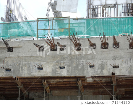 JOHOR, MALAYSIA -APRIL 14, 2017: Pre-stress cable tendons anchor end for pre-stressed concrete at the construction site. It is a technology to get better concrete slab quality with larger span. JOHOR, MALAYSIA -APRIL 14, 2017: Pre-stress cable tendons anchor end for pre-stressed concrete at the construction site. It is a technology to get better concrete slab quality with larger span. 71244150
