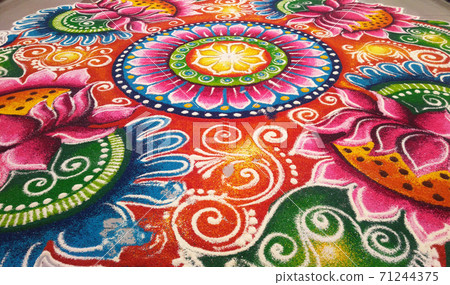 KUALA LUMPUR, MALAYSIA -OCTOBER 16, 2016: Rangoli. Colorful pattern made with colored rice, lentils and powder during Diwali, Hindu New Years and the Hindu Festival of Light. KUALA LUMPUR, MALAYSIA -OCTOBER 16, 2016: Rangoli. Colorful pattern made with colored rice, lentils and powder during Diwali, Hindu New Years and the Hindu Festival of Light. 71244375