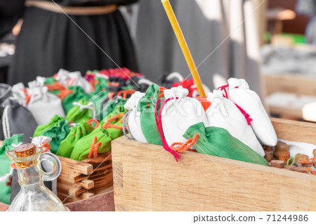 green and white bag of herbs, sachets in a wooden box selective focus 71244986