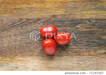 cherry tomato red three vegetables on wooden background cherry tomato red three vegetables on wooden background 71245487